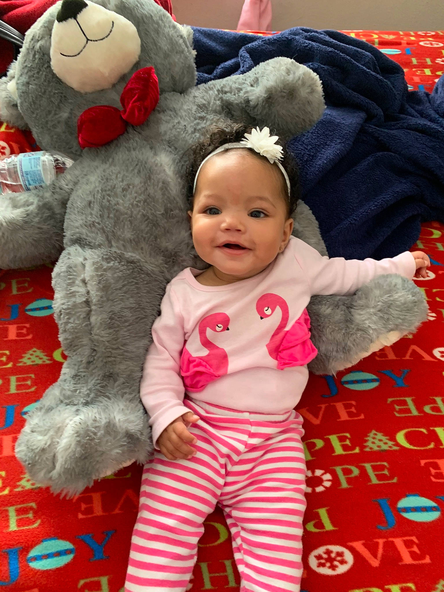 Chosen is registered to the contest to win money with this photo: baby, child, happy, pajamas, person, pink, plush, red, smile, stuffed_toy, textile, toddler, toy