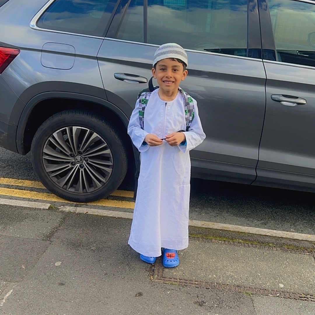 Abdul is registered to the contest to win money with this photo: alloywheel, boy, car, carwheel, child, clothing, coat, face, head, lady, machine, male, person, photography, portrait, spoke, tire, transportation, vehicle, wheel