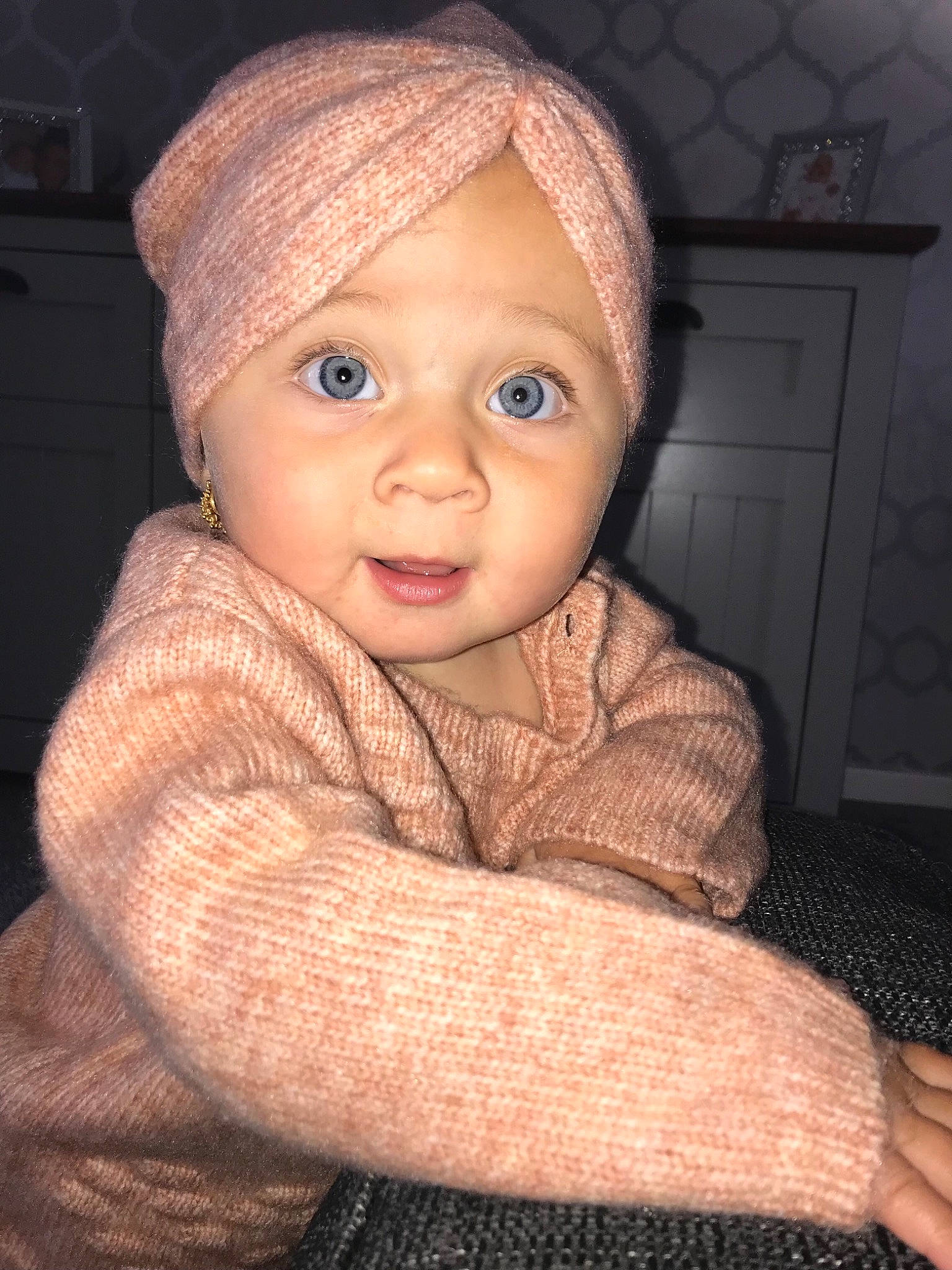 Josie Phillips is registered to the contest to win money with this photo: baby, baby_toddler_clothing, cabinetry, cap, cheek, chin, comfort, eye, face, flash_photography, human_body, iris, lip, nose, outerwear, person, skin, sleeve, smile, standing