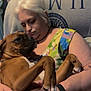 Jasmine Storm is registered to the contest to win money with this photo: woman, dog, boxer_dog, pet, cuddling, blanket, sofa, living_room, home_interior, closeup, affection, hands, pet_owner, relaxed, indoor, portrait, colorful_dress, white_hair, smartwatch, companion