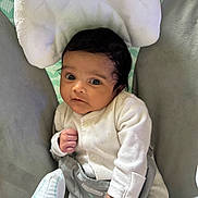 Leandra joined the competition — help win amazing prizes! baby, infant, onesie, face, eyes, hand, cushion, seat, fabric, clothing, child, newborn, cute, indoor, portrait, soft, comfort, expression, skin, person