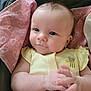 baby, infant, yellow_onesie, bee_design, pink_blanket, heart_pattern, hands, clasped_fingers, face, eyes, skin, cute, portrait, indoor, soft_light, child, newborn, comfort, expression, person