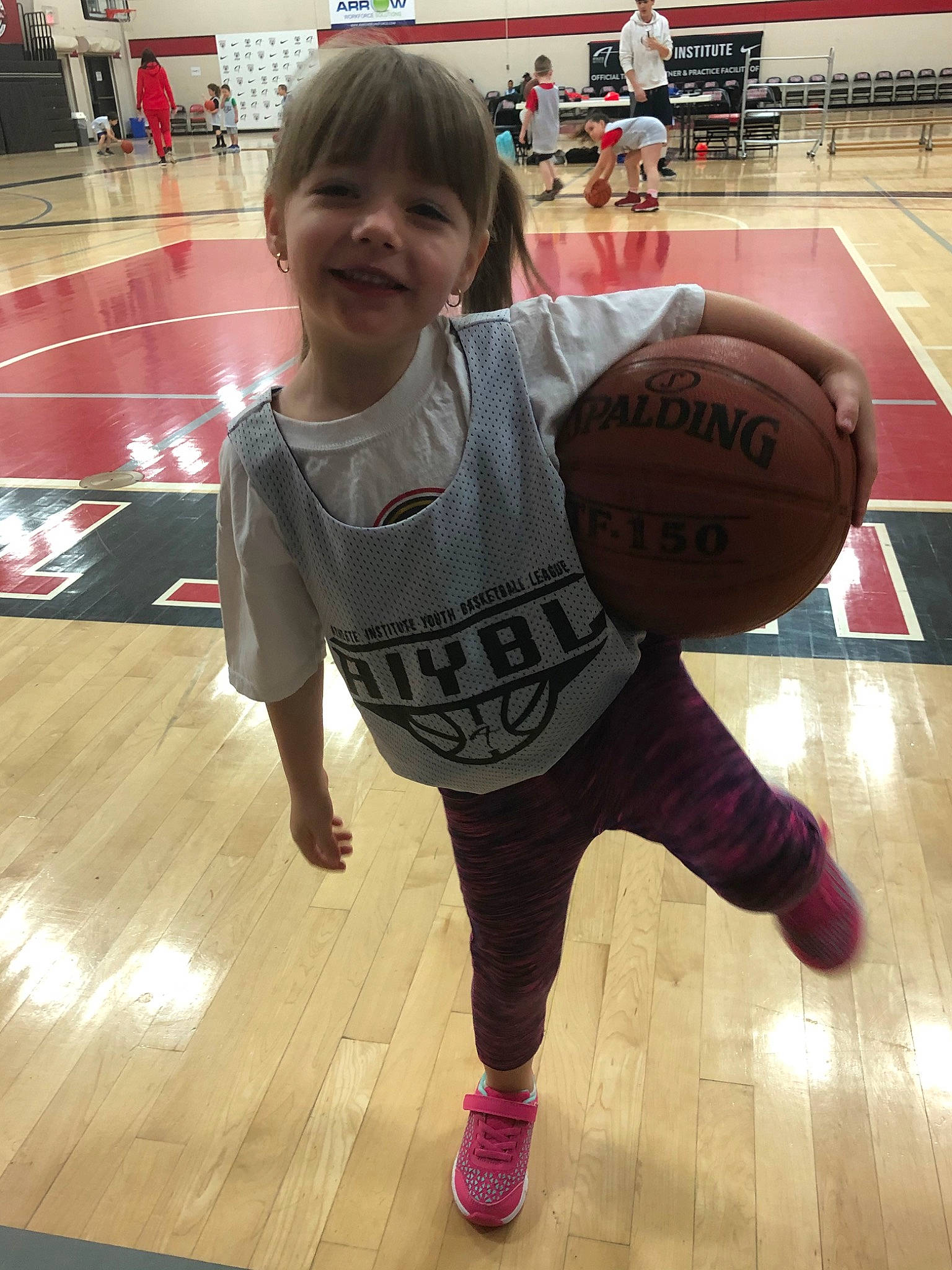 Teghan is registered to the contest to win money with this photo: ball, ball_game, basketball, floor, fun, joy, knee, person, sport_venue, sports, sports_equipment, sportswear, team_sport