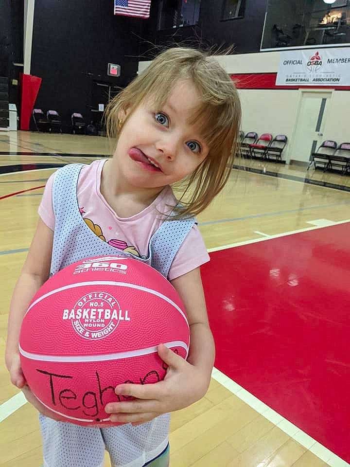 Teghan is registered to the contest to win money with this photo: ball, ball_game, basketball, child, competition_event, fun, netball, person, pink, play, sport_venue, sports, sports_equipment, team_sport, womens_basketball