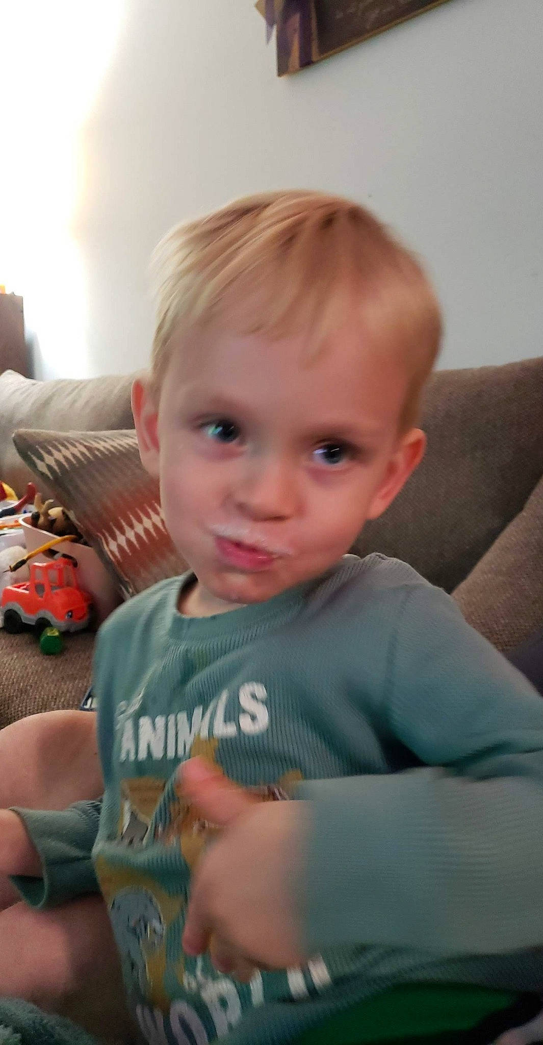 Theodore joined the competition — help win amazing prizes! arm, baby, brown_hair, cheek, child, couch, elbow, finger, flooring, fun, happy, iris, nose, person, play, room, sitting, sleeve, smile, t_shirt