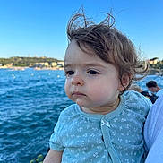 Lilyrose participe au concours pour gagner de l'argent avec cette photo : toddler, child, portrait, outdoor, sea, water, blue_sky, clothing, person, hair, face, nature, daylight, coast, casual, expression, young_child, cute, baby, scenic