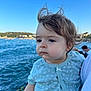 toddler, child, portrait, outdoor, sea, water, blue_sky, clothing, person, hair, face, nature, daylight, coast, casual, expression, young_child, cute, baby, scenic