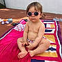 toddler, child, sunglasses, pink, beach_towel, colorful, bare_chest, outdoor, sunny, tiles, toys, shoes, sitting, cross_legged, summer, cute, baby, relaxed, shade, playtime