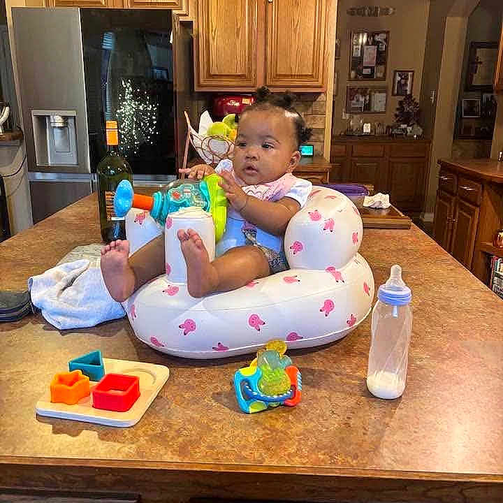 De'Ari is registered to the contest to win money with this photo: baby, infant, toy, bottle, kitchen, countertop, seat, inflatable, cabinet, wood, refrigerator, food, child, cute, indoor, table, play, colorful, person, home