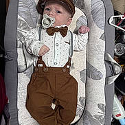 Nehemiah joined the competition — help win amazing prizes! baby, infant, pacifier, bow_tie, cap, suspenders, brown_pants, baby_lounger, leaf_pattern, clothing, cute, lying_down, indoors, child, newborn, fashion, comfortable, small_hands, face, portrait
