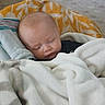 Nehemiah is registered to the contest to win money with this photo: baby, sleeping, blanket, cushion, indoor, cozy, child, infant, soft, rest, comfort, face, head, person, peaceful, nap, warm, home, portrait, toddler