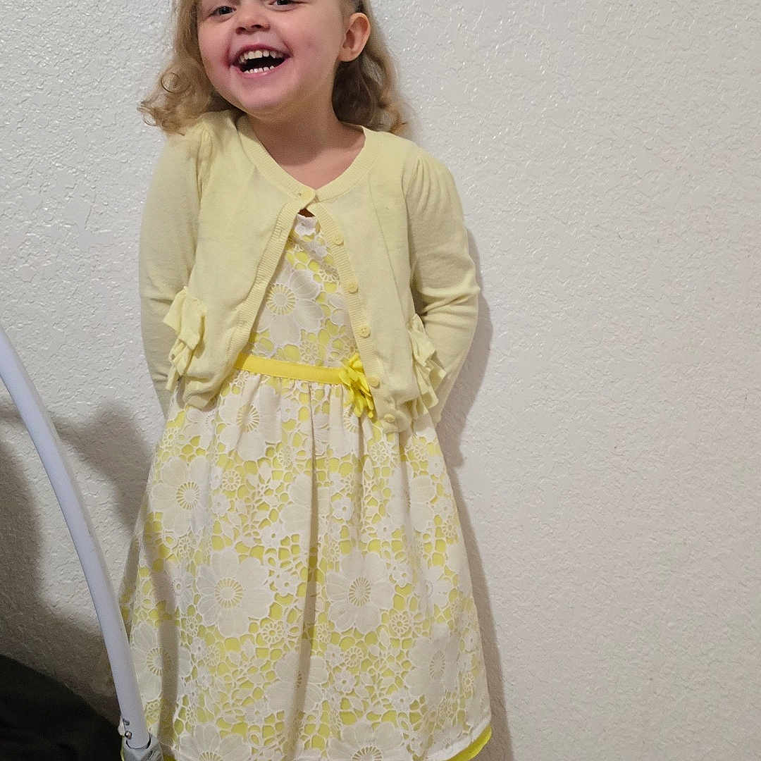 Harper is registered to the contest to win money with this photo: bodypart, child, clothing, dress, face, female, formalwear, girl, happy, head, laughing, longsleeve, mouth, pants, person, photography, portrait, sleeve, smile, teeth