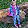 Bexley is registered to the contest to win money with this photo: accessory, backpack, bow, casual_clothing, child, cute, denim_jacket, footwear, girl, grass, happy, jeans, nature, outdoor, person, pink_shoes, rock, smile, standing, young