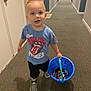 Waylon joined the competition — help win amazing prizes! child, toddler, boy, hallway, carpet, bucket, candy, blue_bucket, shorts, shirt, rolling_stones, walking, indoor, door, carpeted_floor, curious, blond_hair, casual_clothing, footwear, young_child
