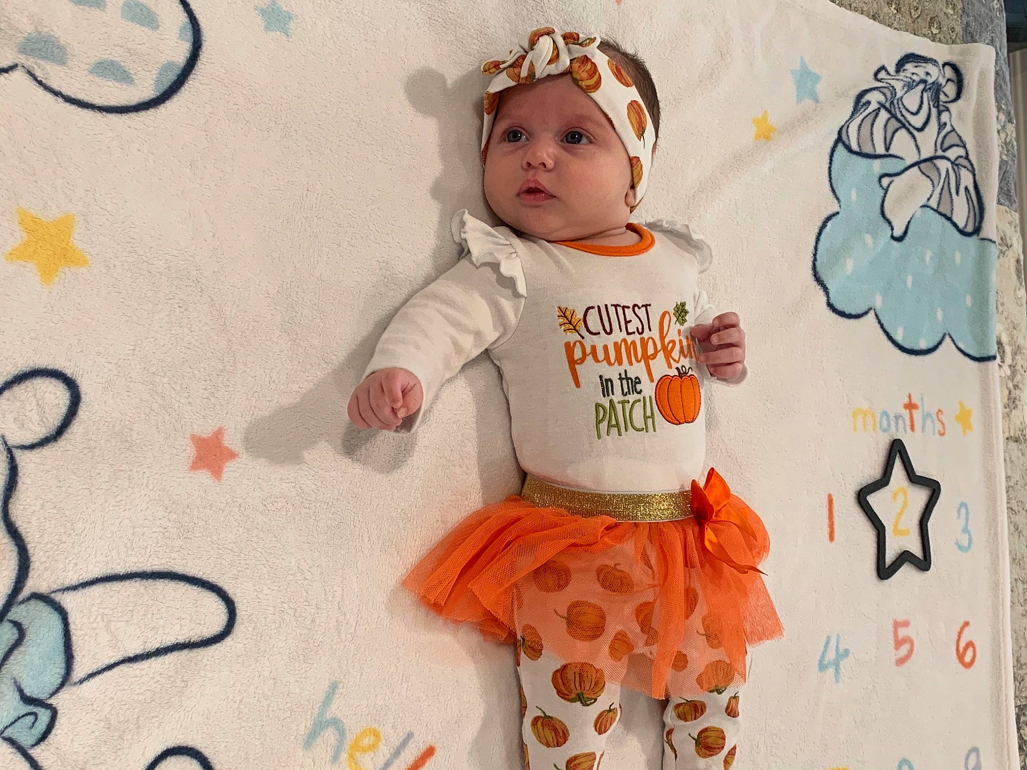 Finley joined the competition — help win amazing prizes! arm, baby_toddler_clothing, cheek, eye, font, happy, hat, head, headwear, mammal, orange, outerwear, pattern, person, pink, product, sleeve, t_shirt, textile, toddler