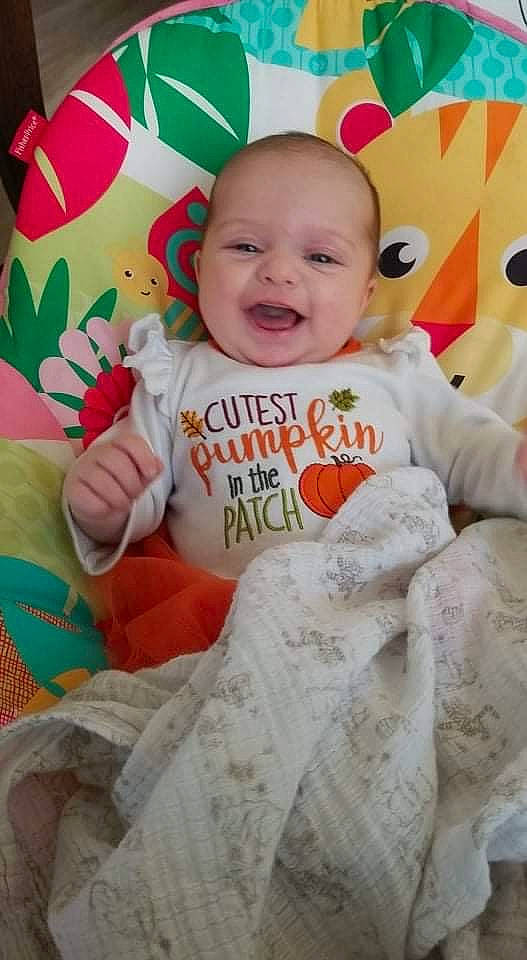 Finley is registered to the contest to win money with this photo: baby, baby_laughing, baby_toddler_clothing, cheek, child, chin, face, happy, head, human, linens, orange, person, pink, room, skin, sleeve, smile, t_shirt, textile