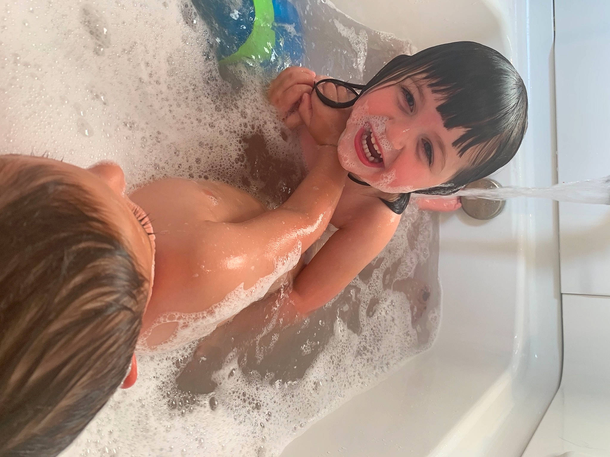 Ainsley is registered to the contest to win money with this photo: barechested, bathing, bathroom, bathtub, chest, child, fun, hair, hairstyle, happy, leisure, person, plumbing, plumbing_fixture, skin, smile, swimming_pool, swimwear, tap, toddler
