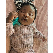Heiress J is registered to the contest to win money with this photo: baby, sleeping, pacifier, headband, bow, knitwear, ribbed_clothing, pink_blanket, infant, cute, peaceful, hand, portrait, soft_lighting, closeup, child, resting, indoors, cozy, adorable