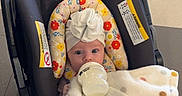 Maple is registered to the contest to win money with this photo: baby, bottle, blanket, car_seat, child, indoor, polka_dot, headwrap, hospital, feeding, newborn, infant, floor_tiles, foot, cute, childrens_hospital, baby_clothing, young_child, resting, milk