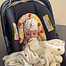 baby, bottle, blanket, car_seat, child, indoor, polka_dot, headwrap, hospital, feeding, newborn, infant, floor_tiles, foot, cute, childrens_hospital, baby_clothing, young_child, resting, milk