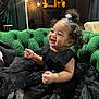 architecture, baby, babylaughing, bodypart, building, clothing, couch, dress, face, furniture, happy, head, indoors, laughing, livingroom, person, photography, portrait, room, smile