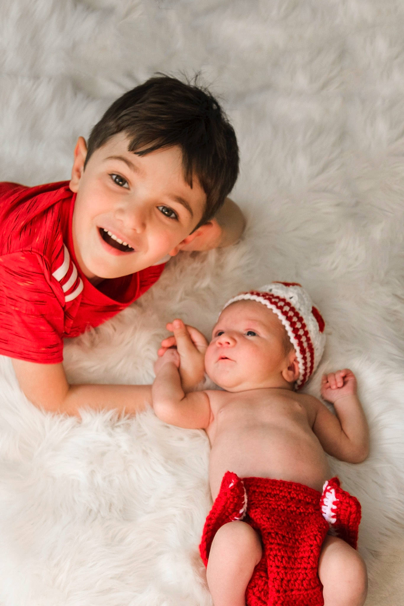 Kieran is registered to the contest to win money with this photo: arm, baby, comfort, eye, facial_expression, finger, flash_photography, fun, gesture, happy, head, human, human_body, joy, mammal, muscle, person, pink, shoulder, skin