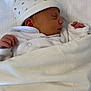 architecture, baby, bed, blanket, bodypart, bonnet, building, cap, clothing, face, finger, furniture, hand, hat, head, newborn, person, photography, portrait, sleeping