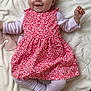 Esmée participe au concours pour gagner de l'argent avec cette photo : baby, child, smiling, pink_dress, floral_pattern, blanket, laying_down, happy, cute, infant, face, small_hands, white_socks, soft_texture, indoors, person, young, legs_crossed, head, eyes