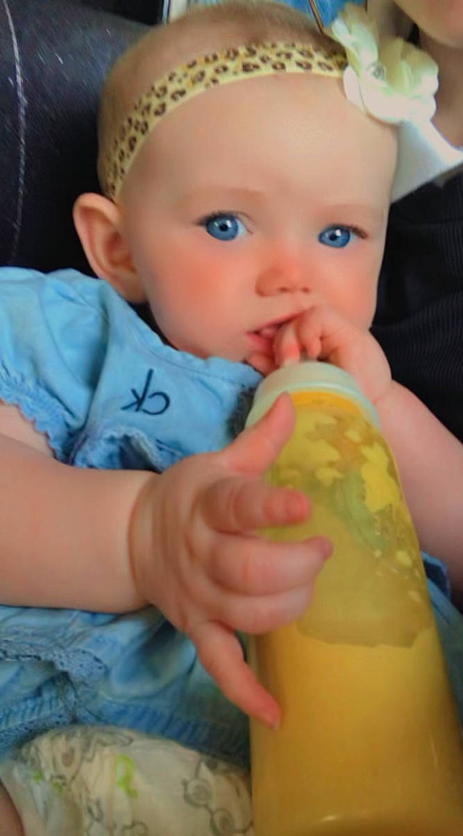 Ellis is registered to the contest to win money with this photo: baby, baby_toddler_clothing, cap, cheek, chin, eye, face, facial_expression, finger, hand, head, iris, lip, mouth, neck, nose, organ, person, skin, toddler