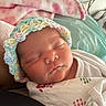 Kylie joined the competition — help win amazing prizes! newborn, baby, sleeping, infant, portrait, close_up, face, crocheted_hat, bonnet, swaddled, blanket, onesie, indoors, bed, cozy, peaceful, sunlight, resting, cute, photography