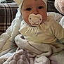 Evie-Jo is registered to the contest to win money with this photo: baby, pacifier, blanket, headband, bow, couch, plaid, indoors, child, soft_texture, clothing, infant, face, eyes, cute, portrait, sitting, window_blinds, water_bottle, cozy