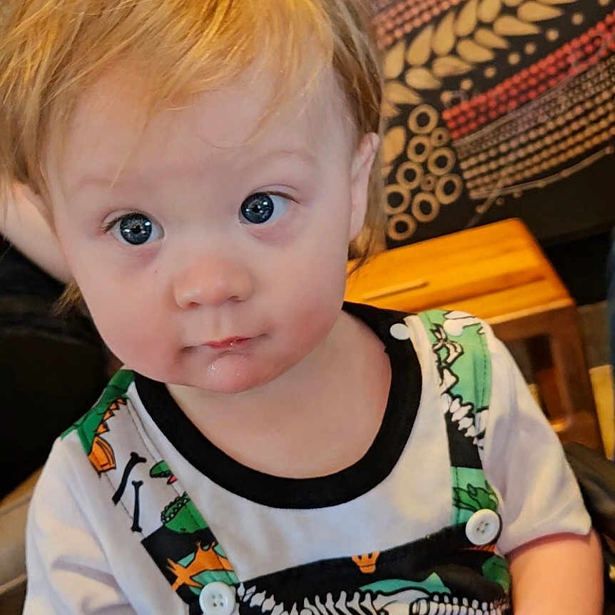 Riven joined the competition — help win amazing prizes! accessories, animal, baby, blonde, clothing, costume, dinosaur, dress, face, hair, head, jewelry, necklace, person, photography, portrait, reptile, shirt, sitting, t_shirt