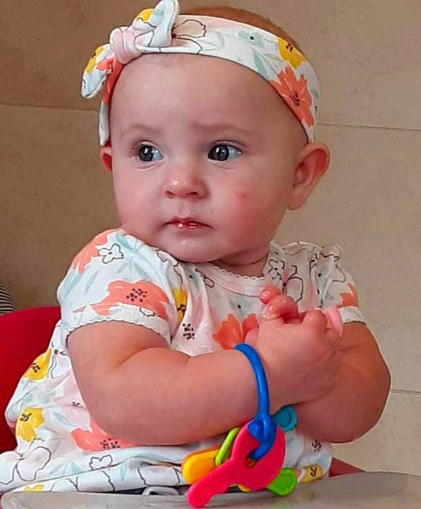 Delyla Sunshine is registered to the contest to win money with this photo: baby, baby_toddler_clothing, cheek, child, dress, eye, eyelash, fun, happy, head, headband, headpiece, headwear, iris, lip, pattern, person, pink, skin, sleeve