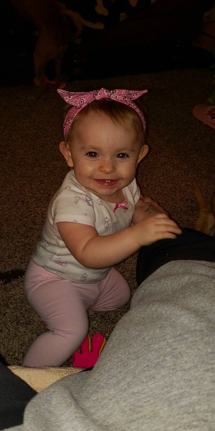 Kovie Luv is registered to the contest to win money with this photo: baby, cheek, child, eye, fun, hat, headgear, iris, joy, person, pink, sitting, skin, smile, toddler