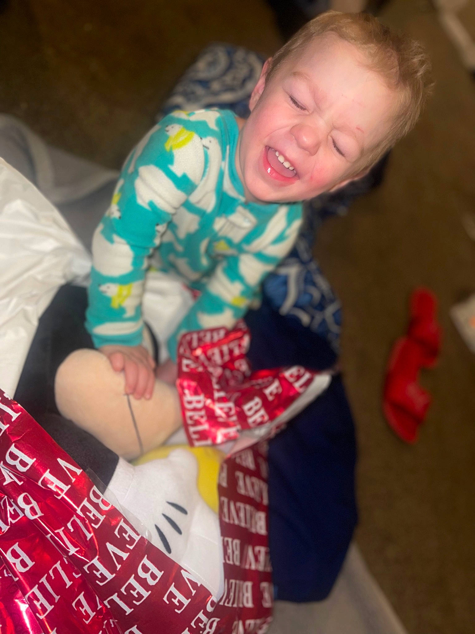Everett is registered to the contest to win money with this photo: baby, baby_toddler_clothing, carmine, cheek, child, comfort, flooring, fun, holiday, human_leg, lap, linens, pattern, person, play, room, sitting, sleeve, smile, thigh