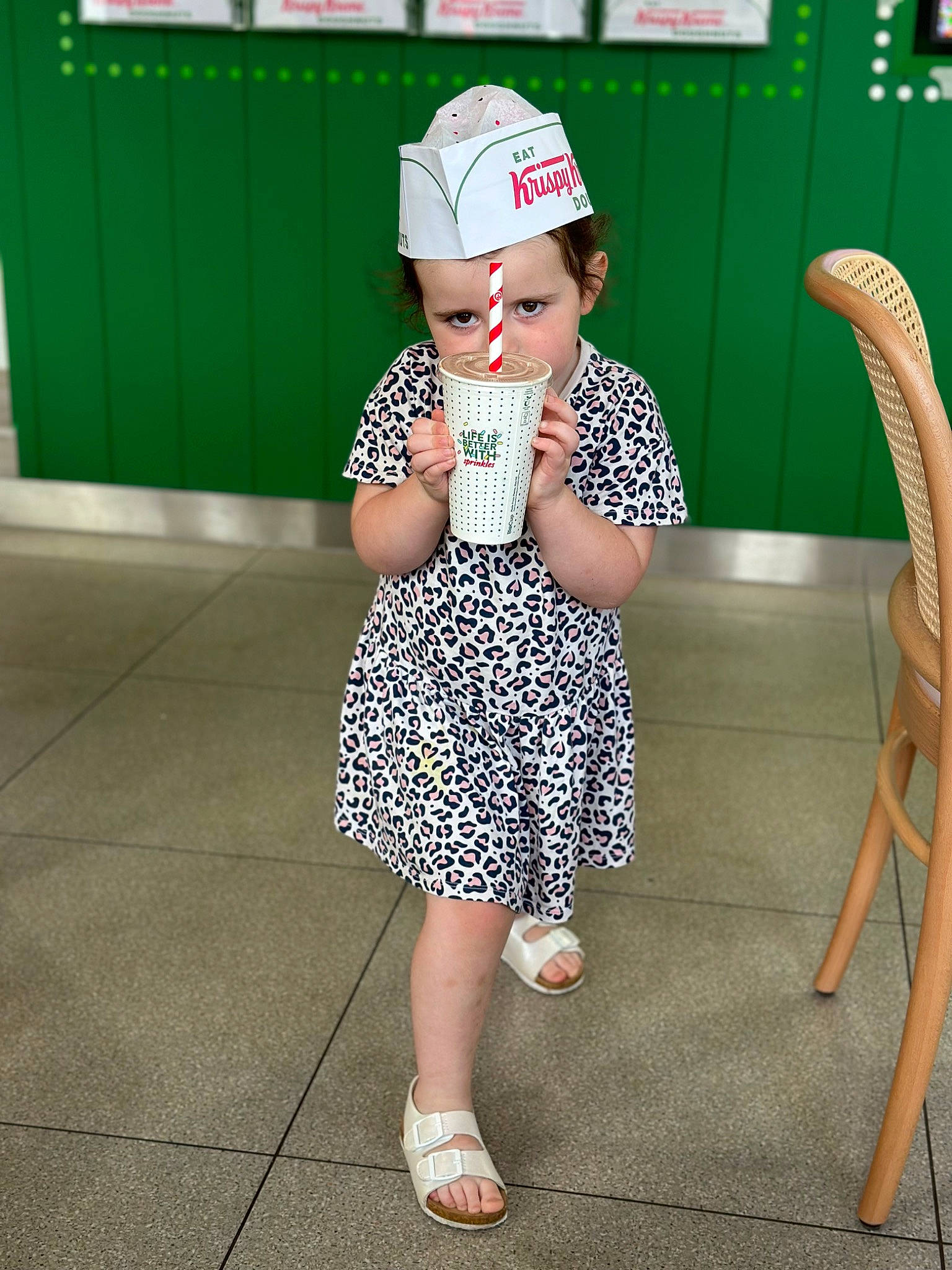 Maddison is registered to the contest to win money with this photo: baseball_cap, cap, child, costume_hat, entertainment, eyewear, fashion_accessory, foot, happy, hat, headwear, human_leg, knee, pattern, person, recreation, sleeve, sun_hat, t_shirt, thigh