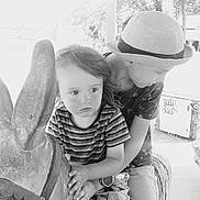 Mao participe au concours pour gagner de l'argent avec cette photo : black_and_white, boy, candid, casual_clothing, child, children, daylight, expression, fun, hands, hat, outdoor, play, playground, portrait, sculpture, siblings, statue, striped_shirt, watch