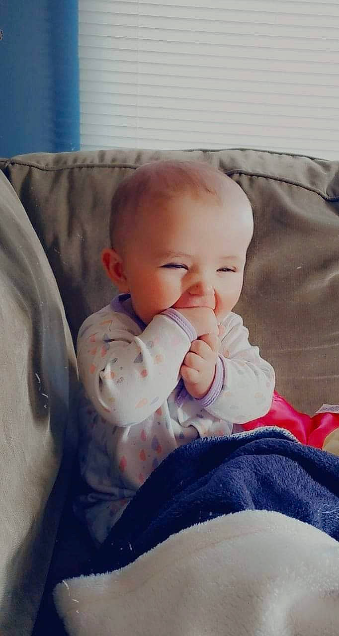 Emma is registered to the contest to win money with this photo: baby, baby_sleeping, baby_toddler_clothing, cheek, comfort, couch, eye, facial_expression, happy, head, iris, knee, leg, mammal, mouth, person, product, skin, sleeve, smile