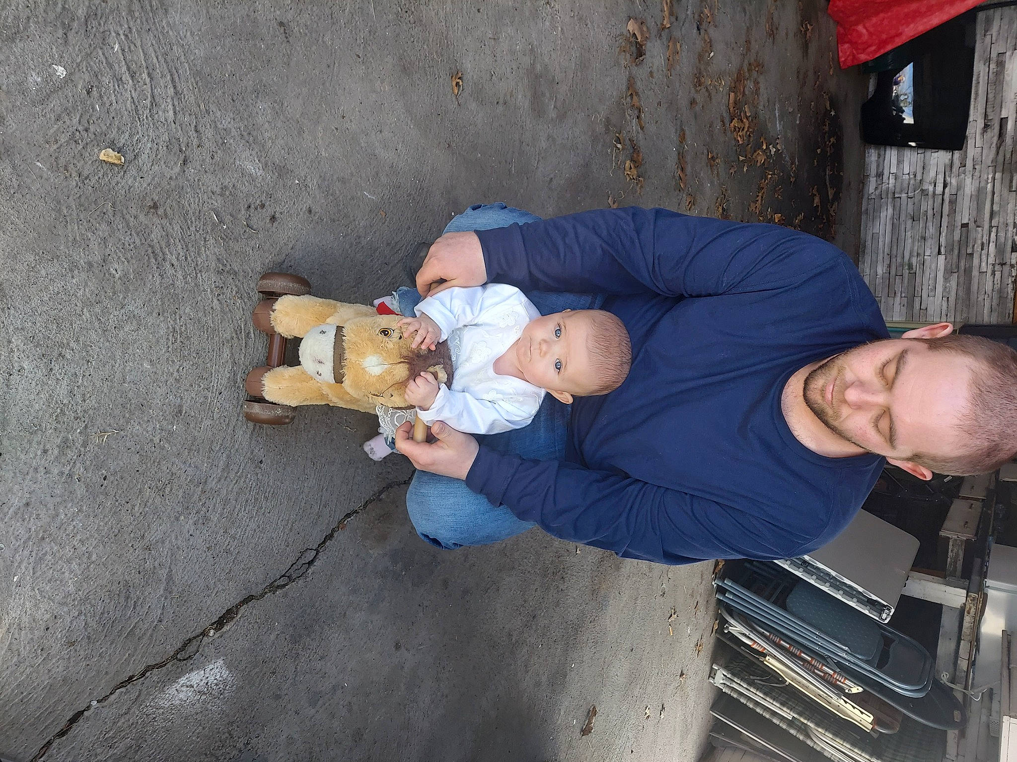 Emma is registered to the contest to win money with this photo: baby, baby_products, baby_toddler_clothing, child, comfort, fun, lap, person, sitting, smile, thigh, toddler, toy, vacation, wood