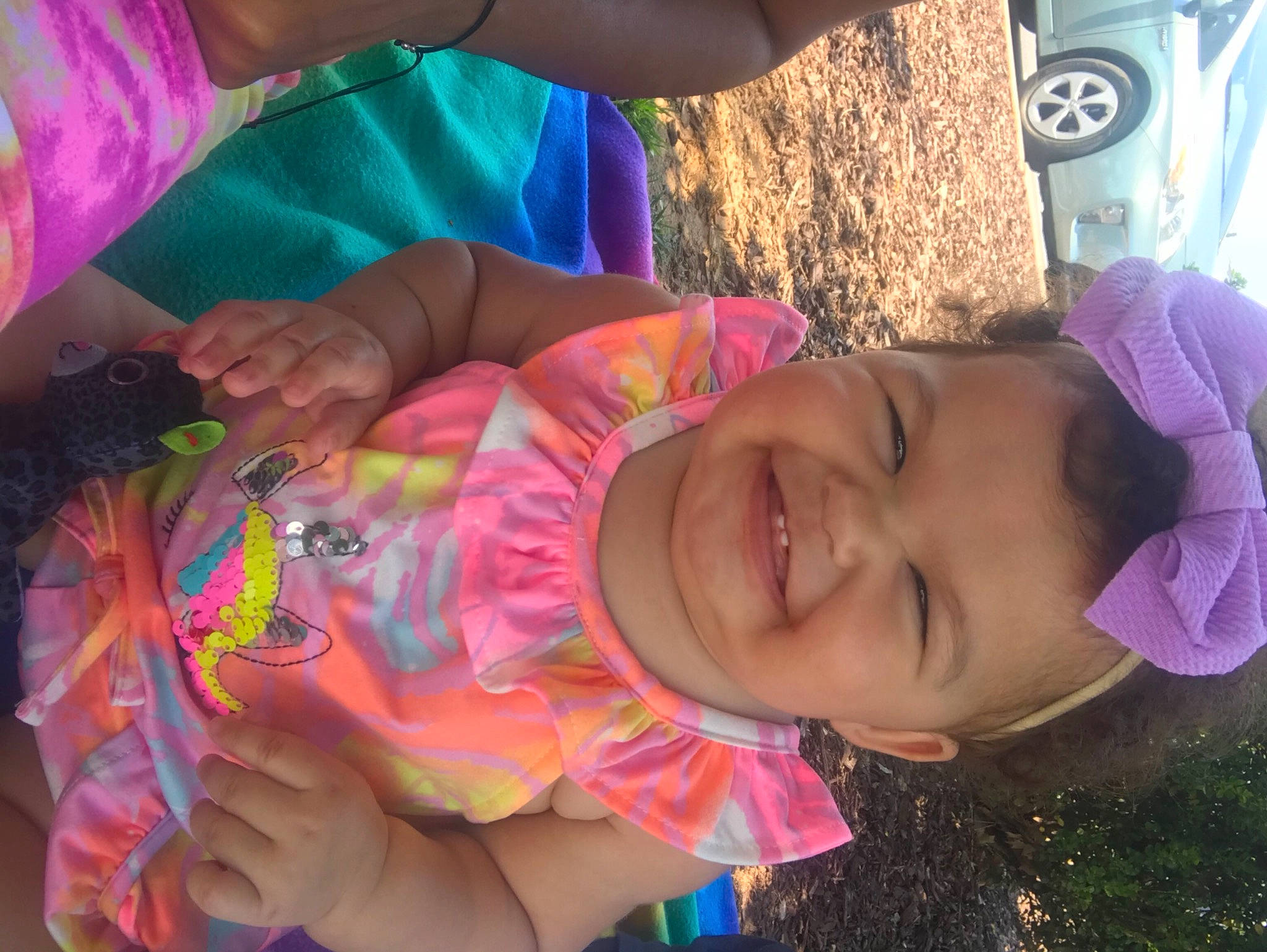 Alisha is registered to the contest to win money with this photo: car, eye, facial_expression, finger, hand, happy, hat, head, human, human_body, joy, leaf, mouth, organ, person, pink, skin, smile, tire, vertebrate