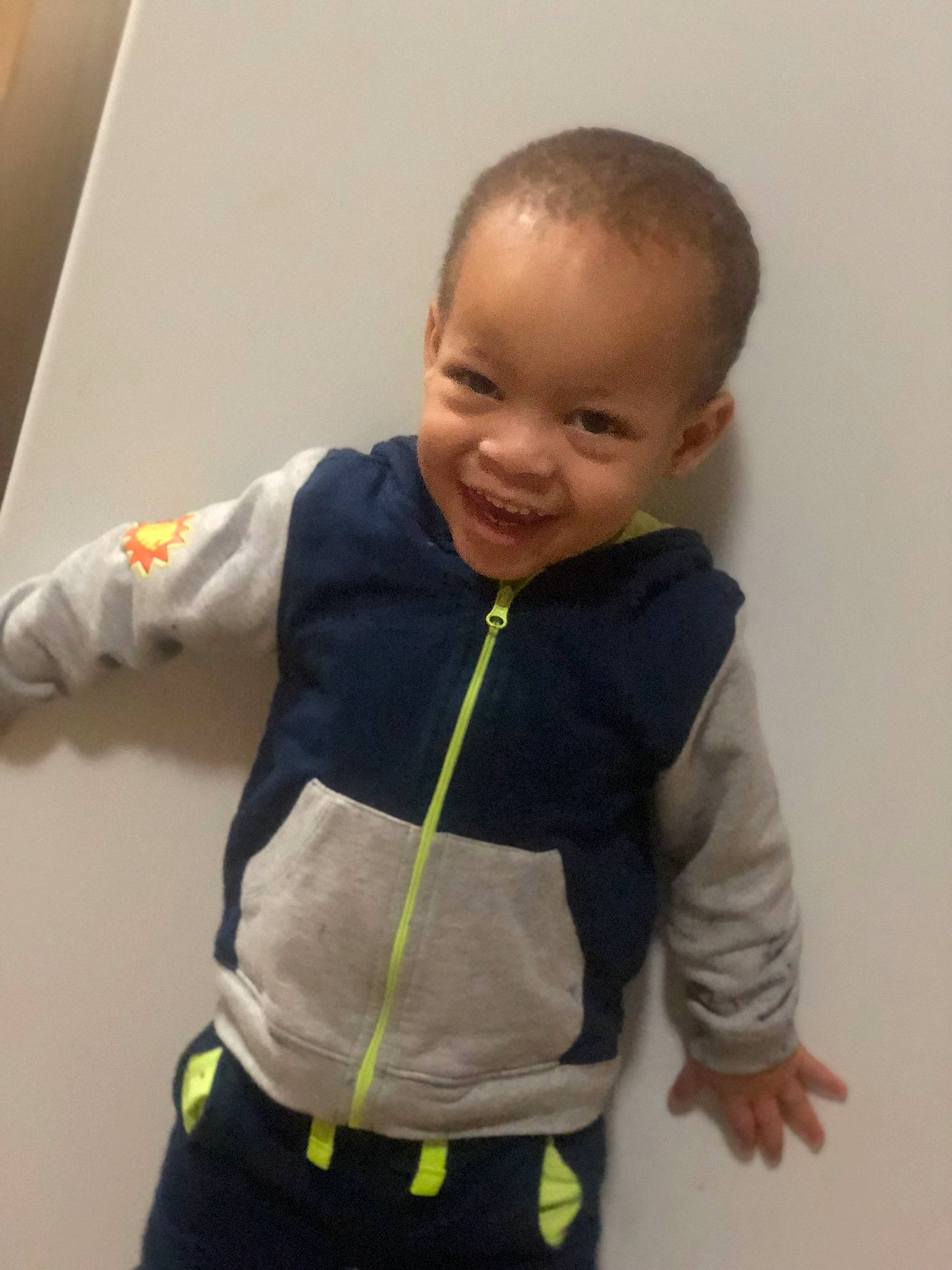 Josiah is registered to the contest to win money with this photo: abdomen, arm, baby, cheek, child, head, hoodie, joint, joy, neck, outerwear, person, play, product, shoulder, skin, sleeve, smile, standing, t_shirt