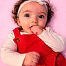 Lillyonna joined the competition — help win amazing prizes! baby, child, infant, headband, flower, red_dress, white_shirt, curly_hair, blue_eyes, hand, sucking_fist, portrait, cute, pink_background, innocence, smiling, happy, person, young, closeup