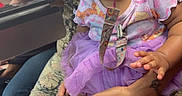 Katyria joined the competition — help win amazing prizes! adult, baby, calm, casual, child, clothing, colorful, curious, curly_hair, cute, hand, indoor, lap, pacifier, people, person, pink_shoes, purple_tutu, sitting, skin