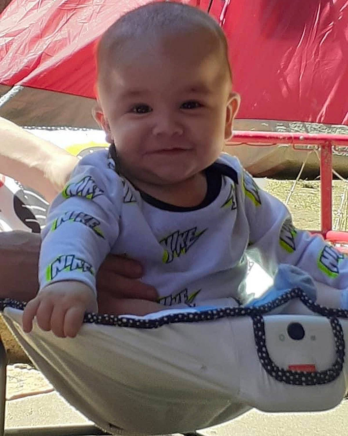 Noah is registered to the contest to win money with this photo: baby, baby_carriage, baby_products, baby_toddler_clothing, bib, carmine, cheek, child, fun, grass, happy, joy, leisure, lip, mouth, person, sitting, skin, sleeve, smile