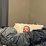 baby, bed, bedding, blanket, child, cozy, face, gray_blanket, home, indoors, infant, looking_at_camera, neutral_expression, peeking, photography, pillow, portrait, sitting, soft_furnishings, textile