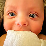 Nathaniel is registered to the contest to win money with this photo: baby, close_up, face, eyes, skin, cloth, cute, infant, adorable, mouth, cheeks, expression, soft, newborn, child, portrait, cute_face, human, young, biting