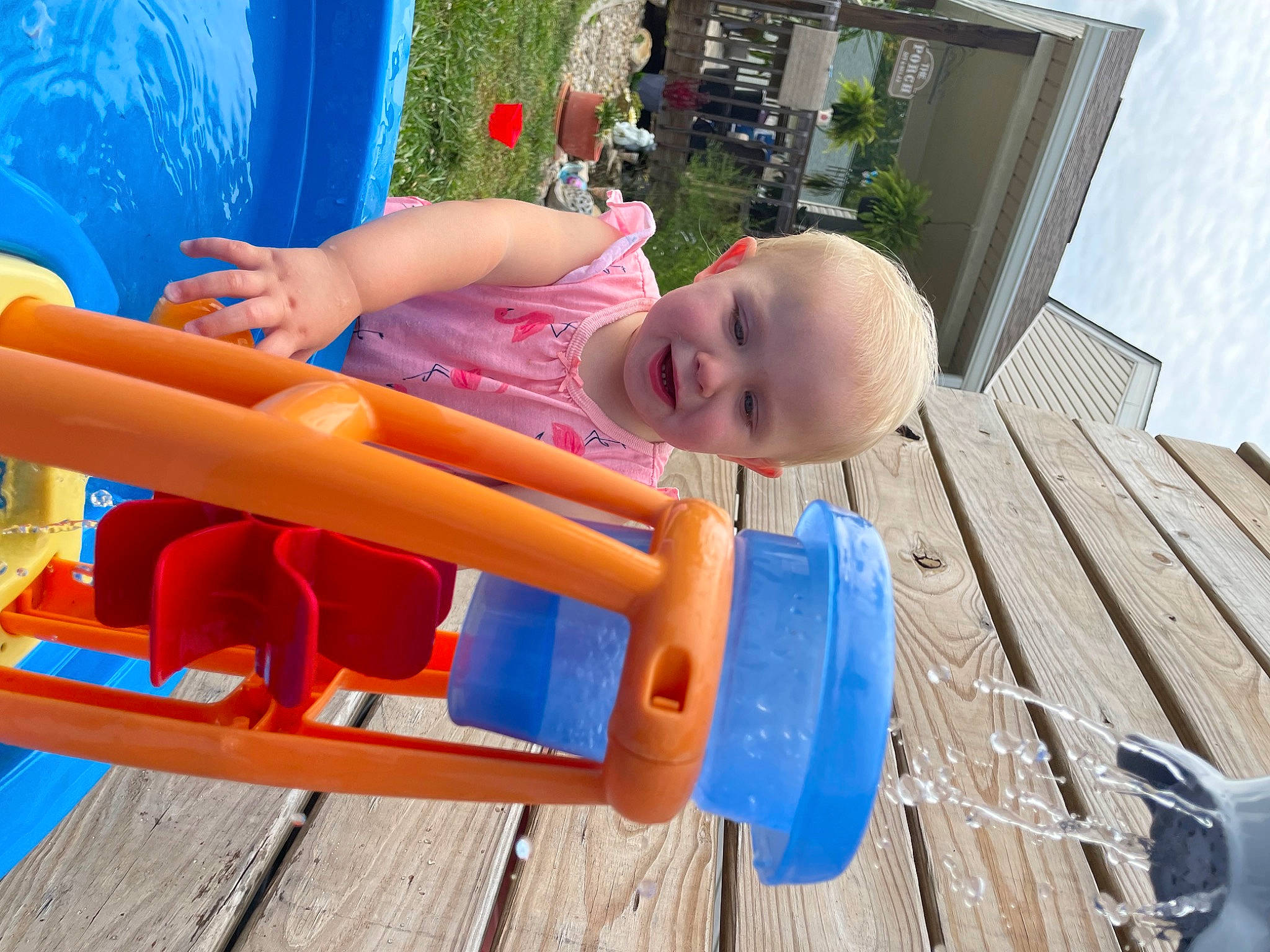 Kallie is registered to the contest to win money with this photo: baby, baby_toddler_clothing, blue, building, child, city, electric_blue, fun, happy, joy, leg, leisure, outdoor_play_equipment, person, plant, recreation, shorts, sky, smile, toddler