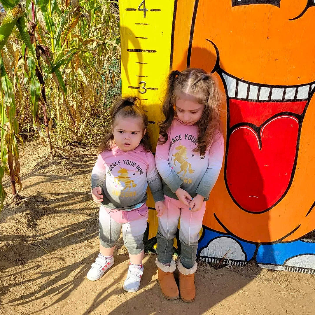 Jaycee is registered to the contest to win money with this photo: art, baby, baby_toddler_clothing, child, facial_expression, fun, grass, happy, leaf, leisure, outdoor_play_equipment, people_in_nature, person, plant, play, recreation, sandal, sitting, toddler, tree