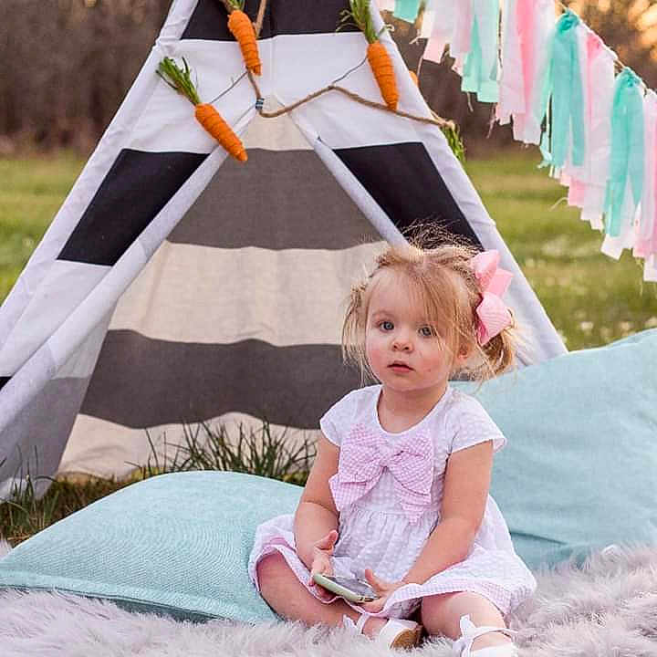 Karter is registered to the contest to win money with this photo: baby, child, furniture, leisure, linens, person, pink, play, product, recreation, room, sitting, tent, toddler