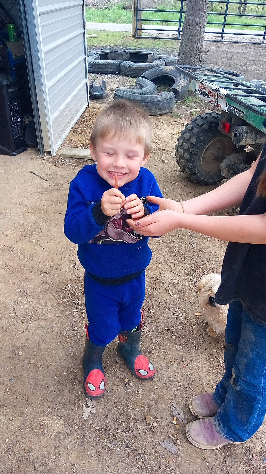 Jared is registered to the contest to win money with this photo: automotive_tire, electric_blue, fender, footwear, fun, gesture, hand, happy, joy, leg, leisure, person, sandal, shoe, smile, sneakers, tire, toddler, travel, tread